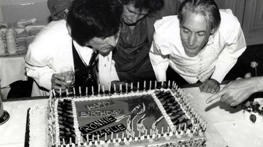 1990: Ronnie Wood, Keith Richards and Charlie Watts blowing out the candles on Ronnie and Charlie's birthday cake. Ronnie is 43 years old and Charlie is 49 years old. Pic: Eugene Adebari/Shutterstock